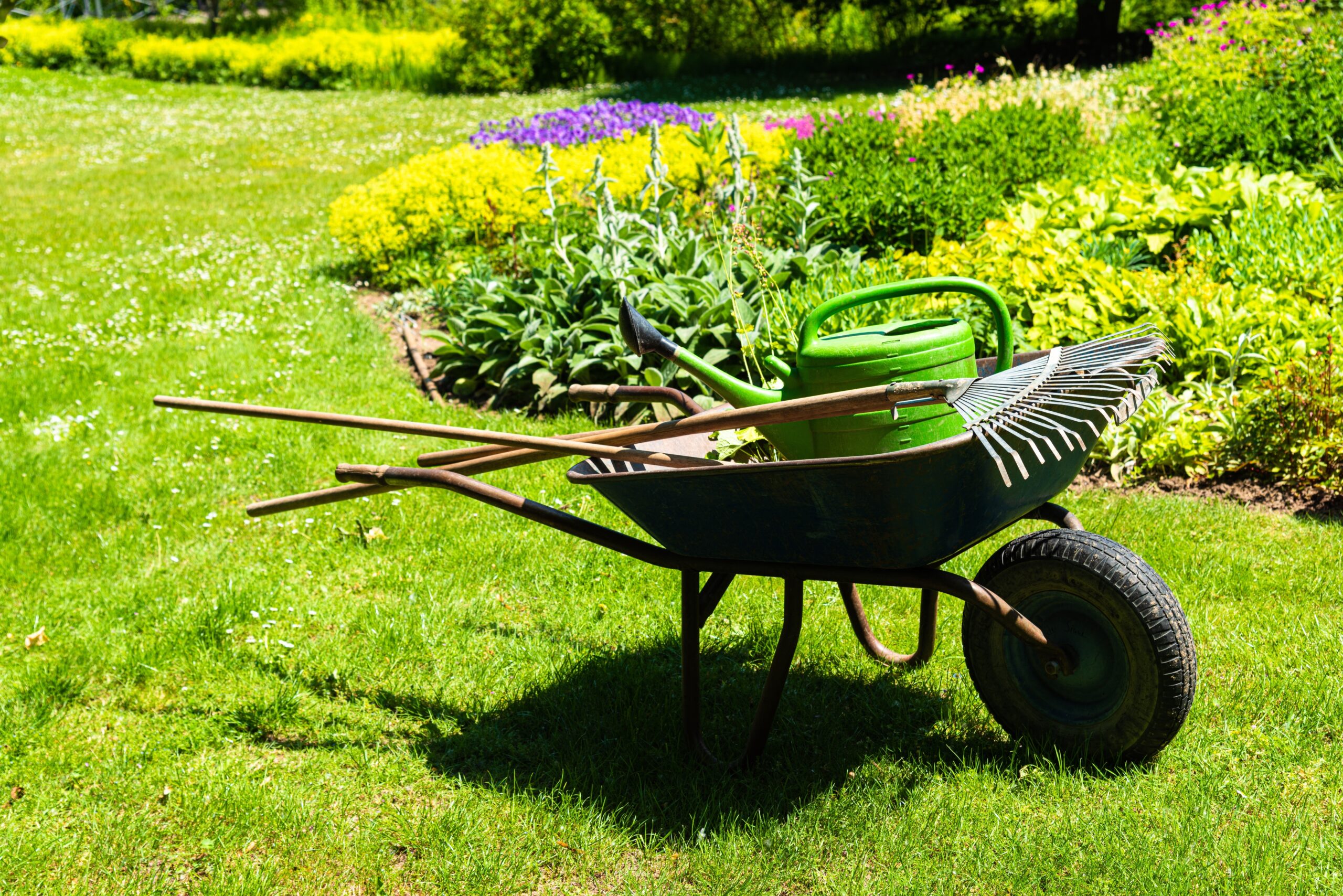 A,Gardeners,Wheelbarrow,With,The,Gardening,Tools,In,The,Gardens.