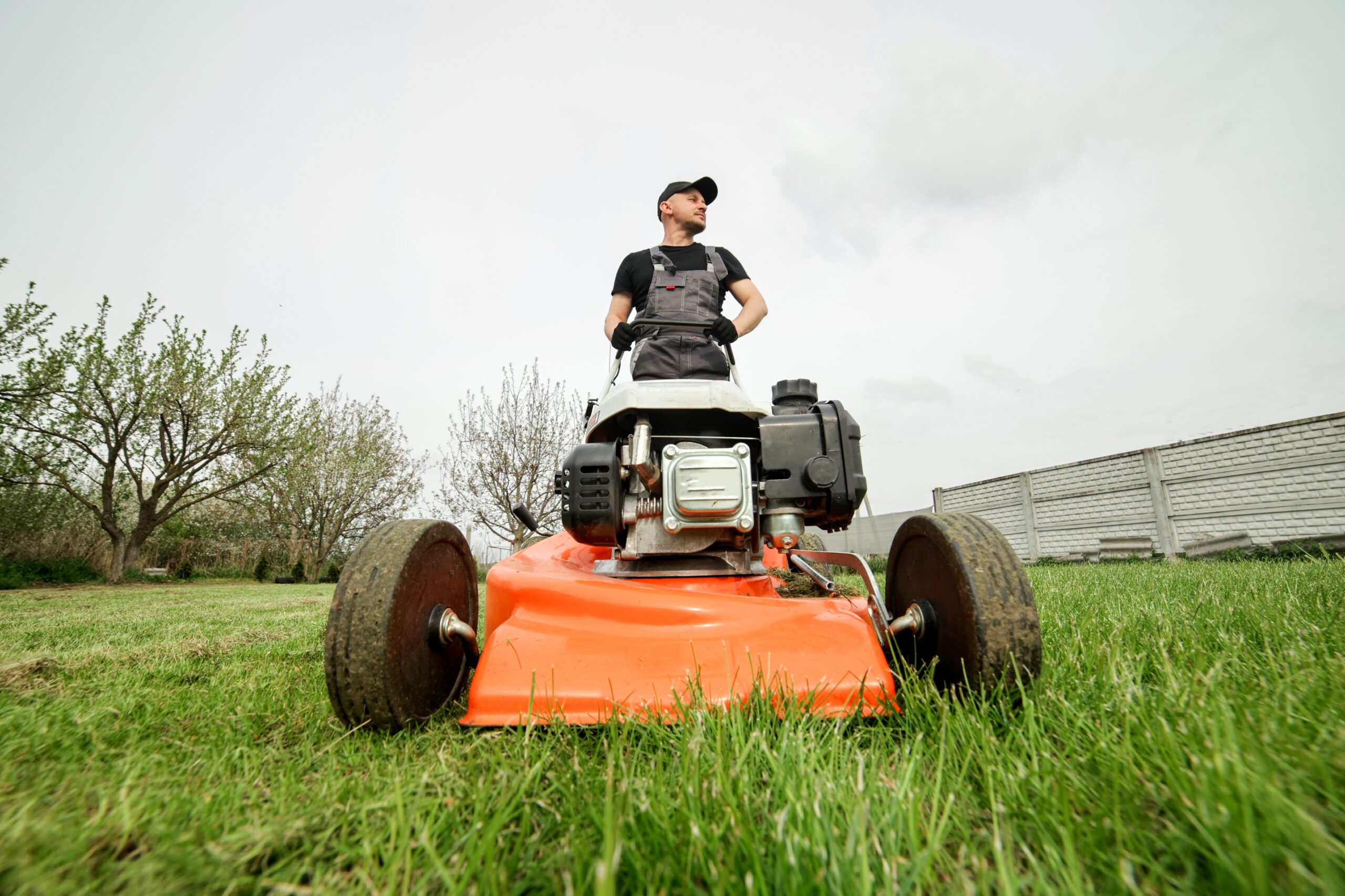 Professional,Gardener,In,Protective,Apparel,Is,Mowing,Green,Grass,Lawn